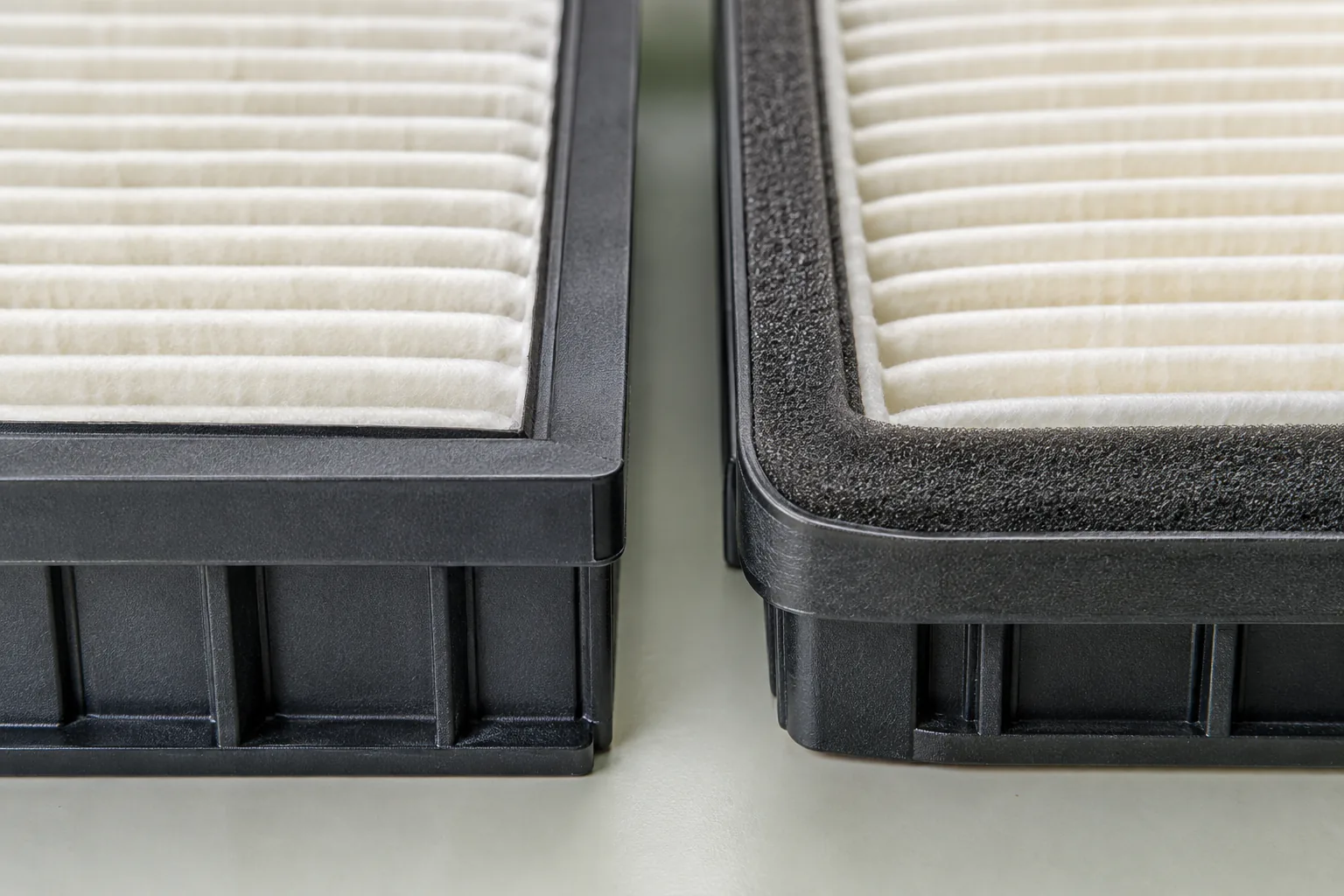 Two generic filter corners side by side under raking light, one rigid frame and one soft edge